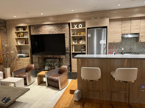 a living room with a bar and a fireplace at Tribecca Modern Brick Wall 3BR 2BA in New York