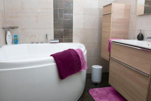 a bathroom with a white bath tub and a sink at Birgits Lodge in Rheinbach