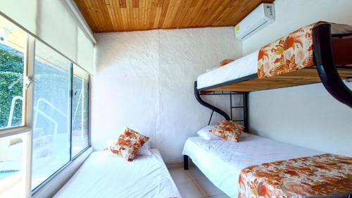 a room with two bunk beds and a window at Villa Marfelia Spa in Ricaurte