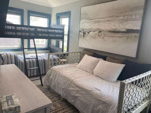 a bedroom with a bed and a bunk bed at Modern Cottage Retreat in Charlevoix