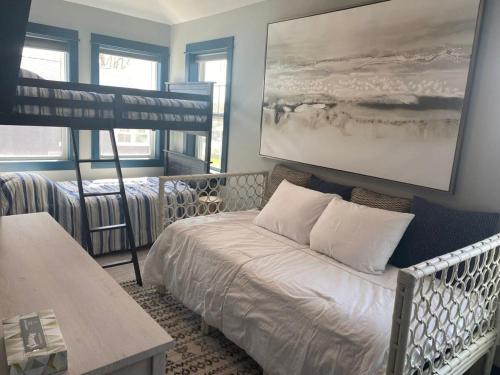 a bedroom with a bed and a bunk bed at Modern Cottage in the Heart of Charlevoix in Charlevoix