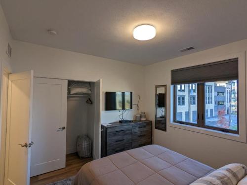 a bedroom with a large bed and a window at Capri Condo in Downtown Traverse City in Traverse City