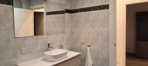 a bathroom with a sink and a mirror at Apartamento Zabala conoce Bilbao desde dentro in Bilbao