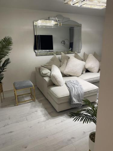 a living room with a white couch and a mirror at Inviting 1-Bed Apartment in London in London