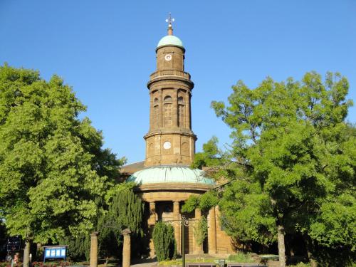a building with a clock tower on top of it at Fairlawns Guest House in Banbury