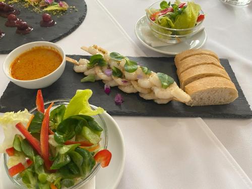 a plate of food with a sandwich and a salad at Hotel Golden Palace in Göd