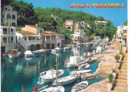 a group of boats are docked in a harbor at Hostal Can Jordi in Cala Figuera