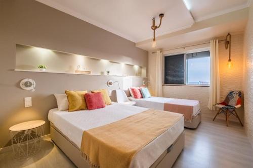 a hotel room with two beds and a window at Saudades do Sol y Mar Apartment in Lagoa