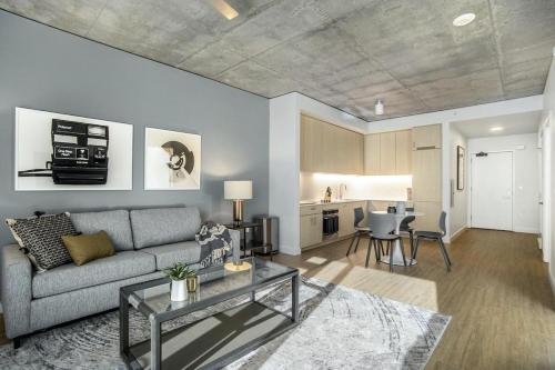 a living room with a couch and a table at Landing - Modern Apartment with Amazing Amenities (ID1403X843) in Chicago