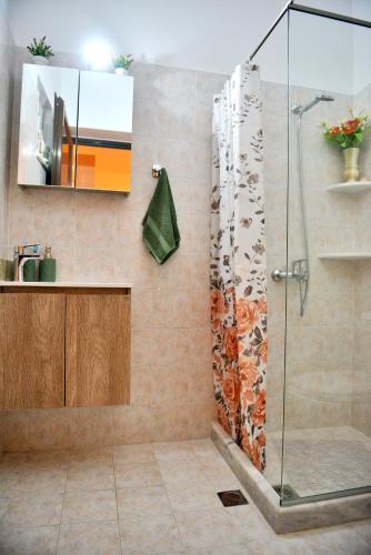 a bathroom with a shower with a sink and a mirror at Villa with private pool Zambakas in Kalithies