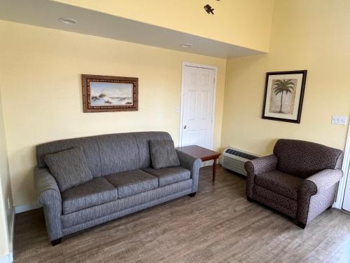 a living room with a couch and a chair at Seashell Village Resort near the beach with kitchens in Port Aransas