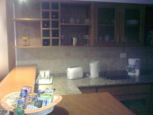 a kitchen counter with a bowl of food on a table at Departamento Los Pinos in Salta