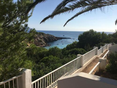 a view of the ocean from a balcony of a house at Las Terrazas de Cala Codolar in Sant Josep de sa Talaia