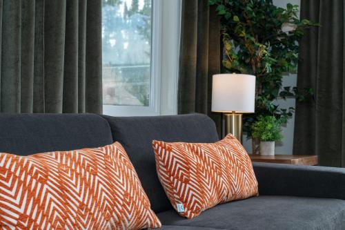a blue couch with two orange and white pillows at Gull Lake Lodge in June Lake