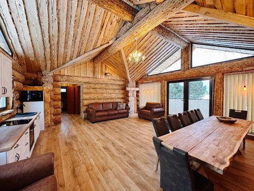 a living room with a wooden table and chairs at Alliku holiday home in Alliku