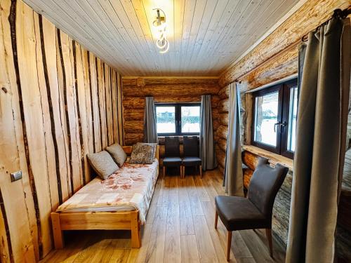 a room with a bed in a wooden cabin at Alliku holiday home in Alliku
