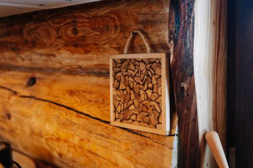 a wooden wall with a box filled with fire wood at Alliku holiday home in Alliku