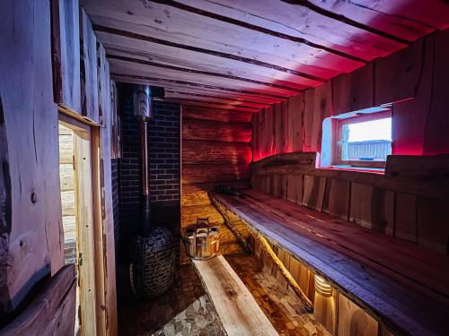 an empty room with a bench in a wooden house at Alliku holiday home in Alliku