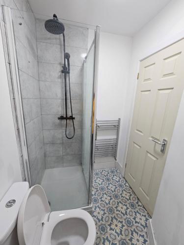 a bathroom with a shower stall and a toilet at Double en suit room in Levenshulme in Manchester