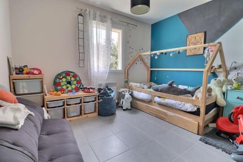 - une chambre pour enfants avec des murs bleus et un lit avec des jouets dans l'établissement Maison cocooning varoise !, à Seillons-Source-dʼArgens