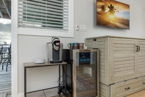 a kitchen with a drink cooler and a table at 3 Story Haven Fire Pit kayaks updated 360 Views in Cedar Key