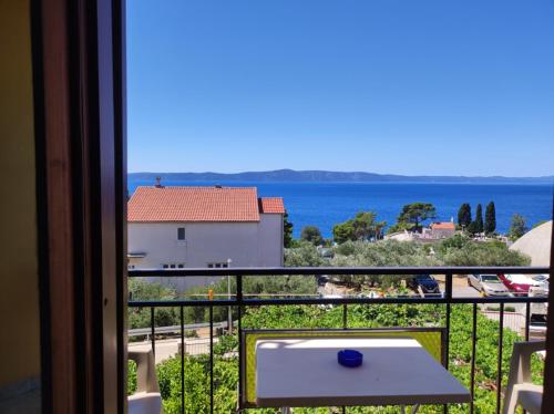 a room with a view of the ocean from a balcony at Apartments Slaven in Podgora