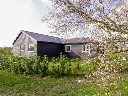 a house on a hill with flowers in front of it at Bramley Cottage in Clacton-on-Sea