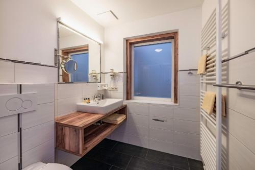 a bathroom with a sink and a mirror at nawu apartments & Restaurant in Hermagor