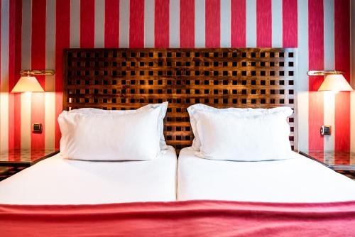 two beds with white pillows in a room at Villa Panthéon in Paris