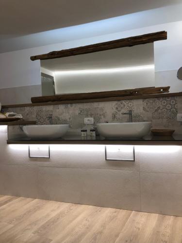 a bathroom with two sinks and a mirror at Villa Fontana in Celle Ligure
