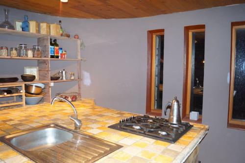 a kitchen counter with a sink and a stove at Un « Time-out  » en couple, famille ou entre amis. in Laragne