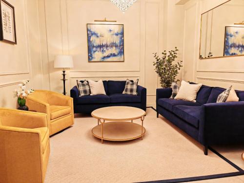 a living room with couches and a table and chairs at Frederick House Hotel in Edinburgh