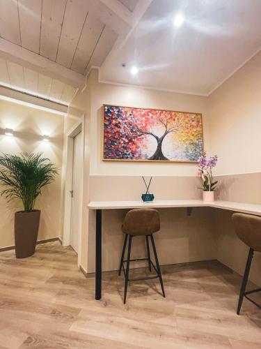 an office with a desk and a painting on the wall at GIO' HOUSE in Fossano