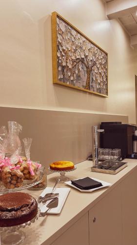 a table with a cake and some food on a counter at GIO' HOUSE in Fossano
