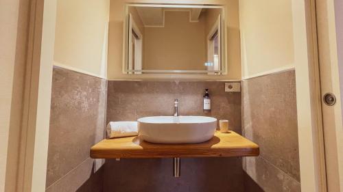 a bathroom with a sink and a mirror at GIO' HOUSE in Fossano