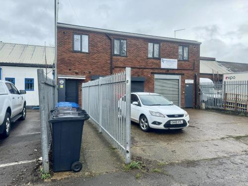 a car parked in a parking lot in front of a building at Modern 1 Bedroom self contained apartment in Welwyn Garden City