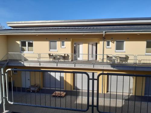 a balcony of a building with tables and chairs at Kleine Auszeit - Ferienwohnungen in Flonheim in Flonheim