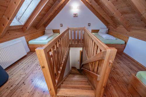 a room with a staircase in a wooden house at nawu apartments & Restaurant in Hermagor
