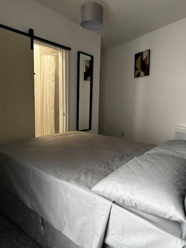 a large white bed in a room with a window at Kos apartment 3 in Walton on the Hill