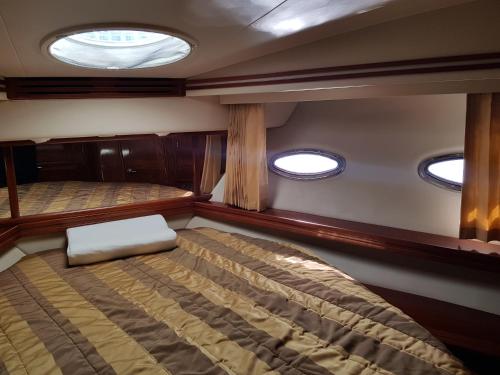 a bedroom in the back of a boat with two beds at Top Luxury Exclusive Fully air conditioned 3bdr Yacht in Eilat