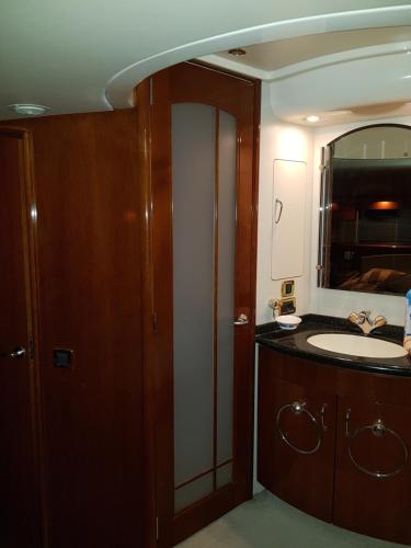 a bathroom with a sink and a mirror at Top Luxury Exclusive Fully air conditioned 3bdr Yacht in Eilat