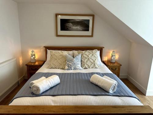 a bedroom with a bed with two pillows on it at Seaview Penthouse in Seaham
