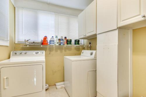 a white laundry room with a washer and dryer at Augusta Home with Fenced Yard - 4 Mi to Downtown! in Augusta