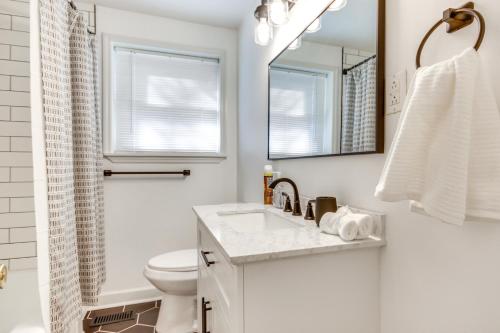 a bathroom with a sink and a toilet and a mirror at Augusta Home with Fenced Yard - 4 Mi to Downtown! in Augusta