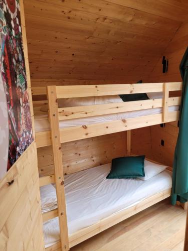 a wooden bunk bed in a wooden room at Utopia Village - Art & Nature Lodges in Mons