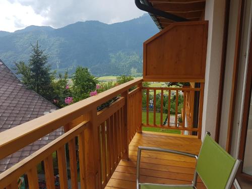 a wooden balcony with chairs and a view of mountains at nawu apartments & Restaurant in Hermagor