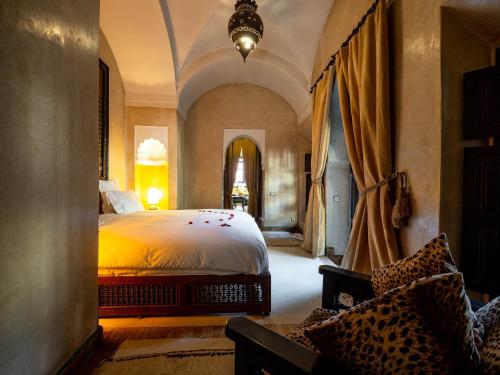 a bedroom with a large bed in a room at Dar Les Cigognes in Marrakech