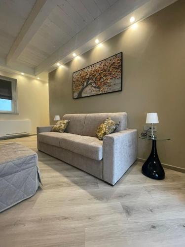 a living room with a couch and a picture on the wall at GIO' HOUSE in Fossano