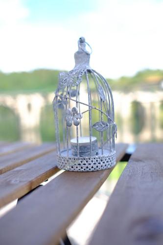 a bird cage sitting on top of a table at Hotel Os Poetas in Ponte da Barca
