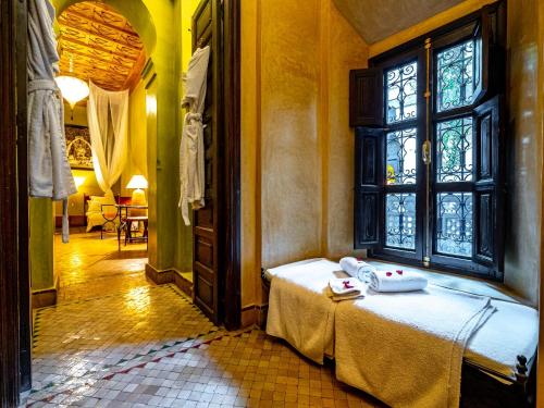 a room with a bed and a window at Dar Les Cigognes in Marrakech